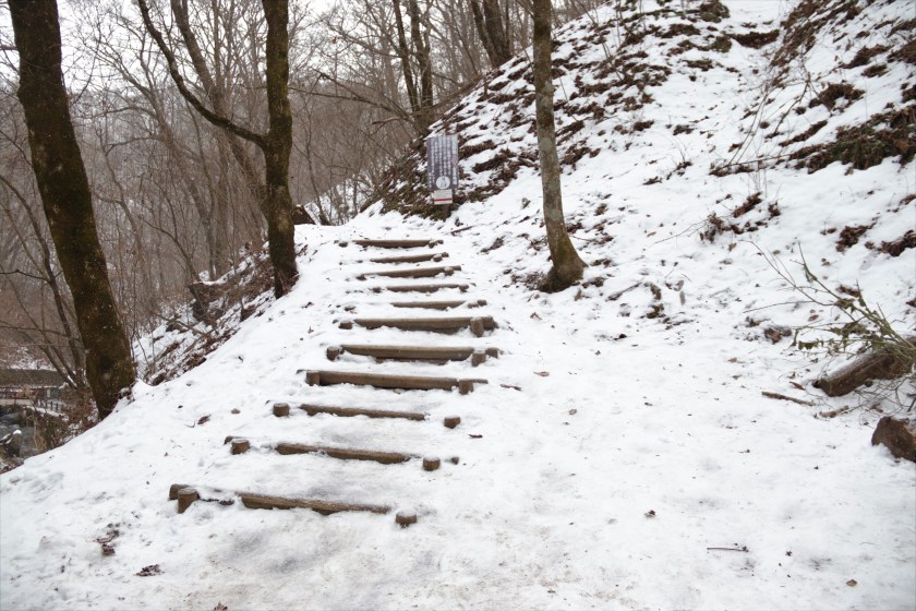 Wooden steps on a snowy slope near Shiraito Falls, Karuizawa, Nagano