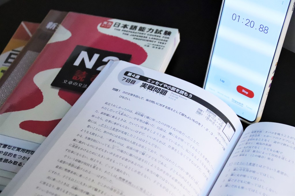 Open-faced book and a smartphone with stopwatch